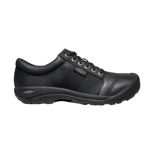 Black low-top walking shoe with lace-up closure and a thick rubber sole