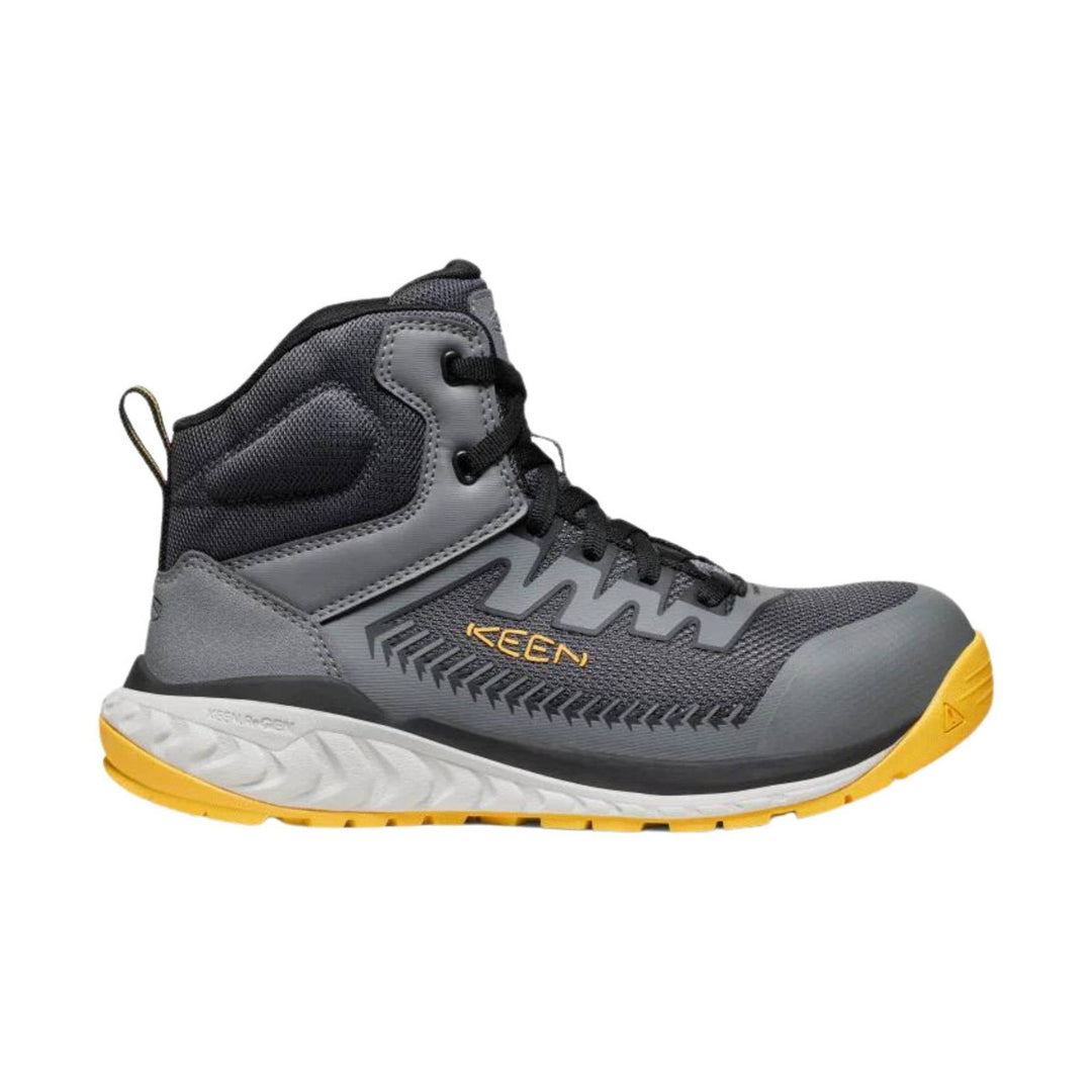 Gray mid-top work boot with black laces, yellow outsole, and side branding