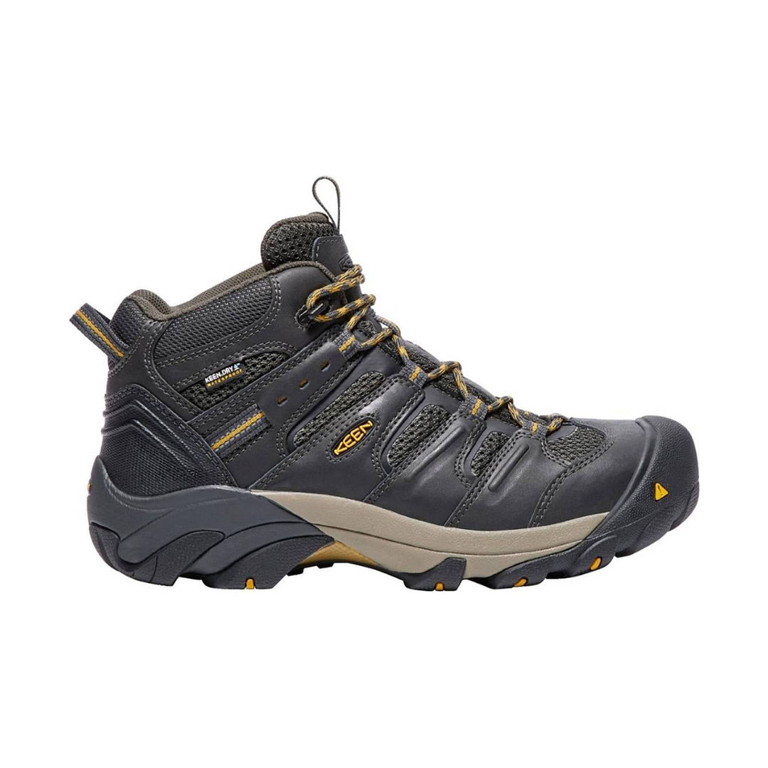 Black mid-height hiking boot with mesh panels, yellow lace accents, and a rubber toe cap