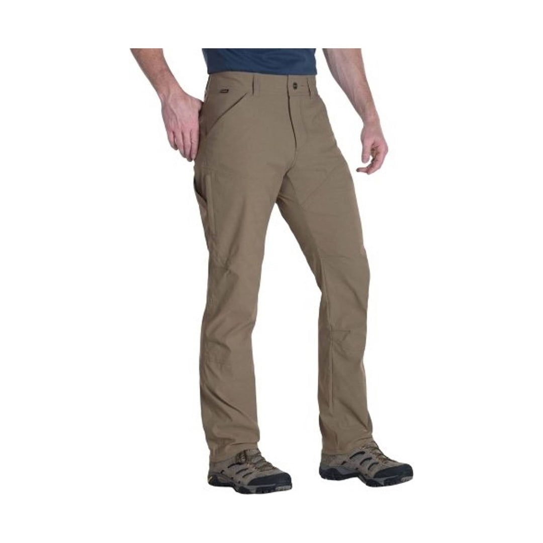 Tan hiking pants with articulated knees, zip pockets, and boots