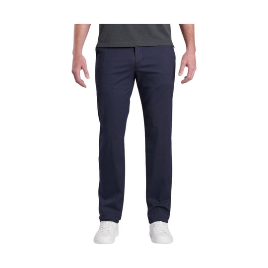 Navy men’s chino pants with straight legs and white sneakers
