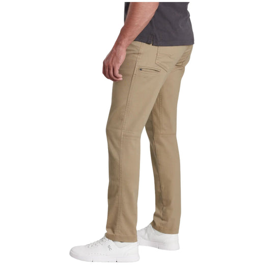Khaki tapered pants shown from the side, paired with white sneakers