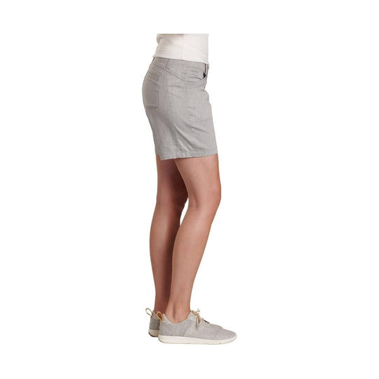 Light gray women’s shorts shown in side view with front pockets and a fitted hem, worn with light gray lace-up shoes