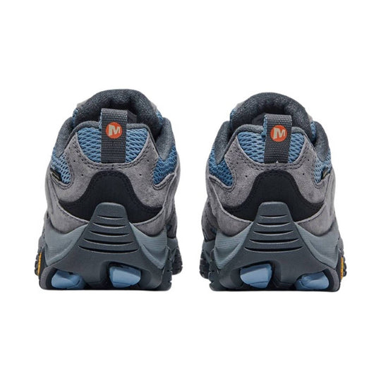 Pair of gray hiking shoes shown from the back with blue mesh panels and orange M heel tabs
