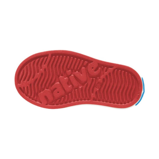 Red shoe sole with textured tread and molded lettering
