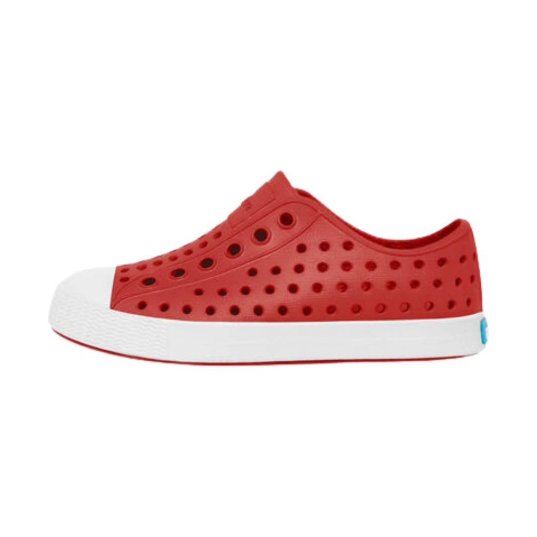 Red toddler slip-on shoe with perforated sides, white platform sole, and a small blue heel tab