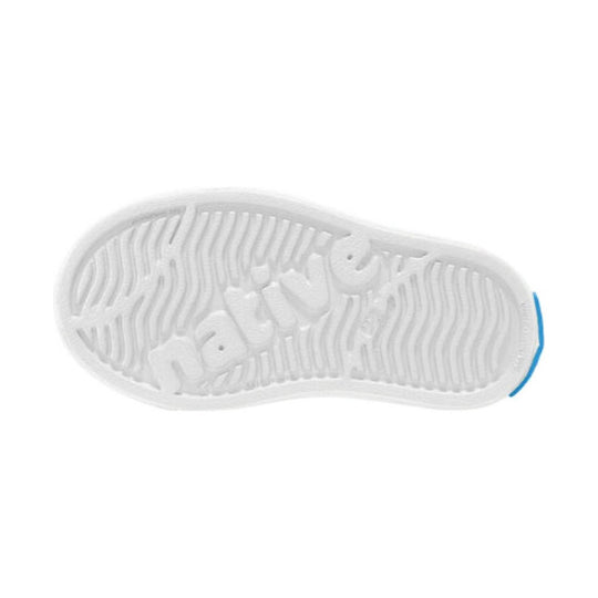 White toddler slip-on sneaker outsole with wavy tread and blue heel accent