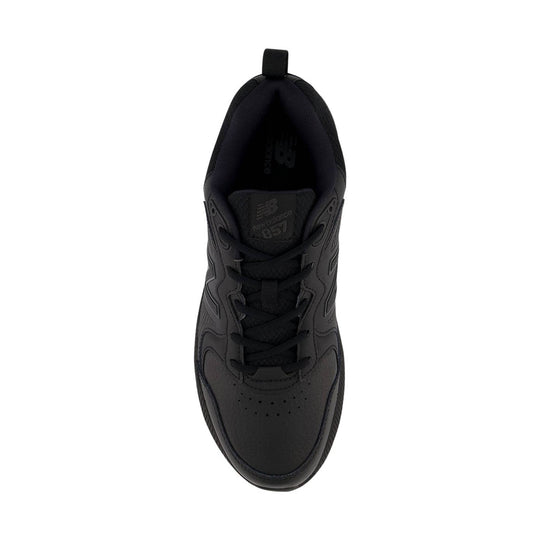 Black athletic shoe viewed from above with laces and a pull tab