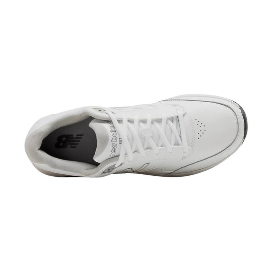 White leather walking shoe with laces, perforated toe box, and padded collar