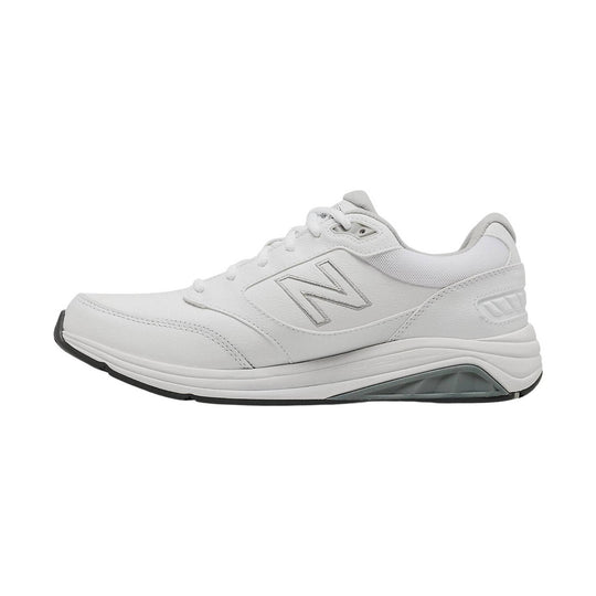 White low-top walking shoe with lace-up closure, mesh panels, and a gray outsole insert