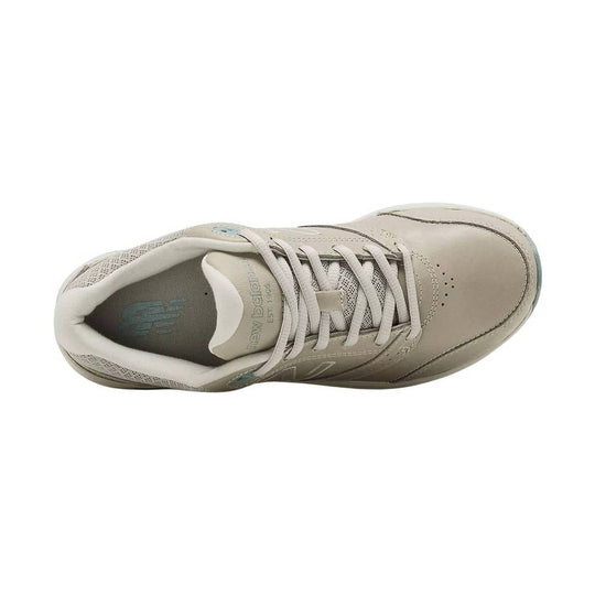 Beige athletic walking shoe with mesh panels, laces, and a rounded toe, shown from above