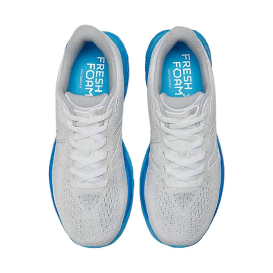 White running shoes with blue soles and blue insoles, shown from above