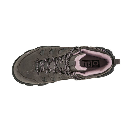 Gray mid-cut hiking boot with pink lining, patterned laces, and rugged black sole, shown from above