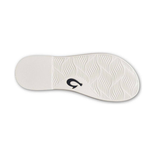 White sandal outsole with wavy tread pattern and a black logo near the arch