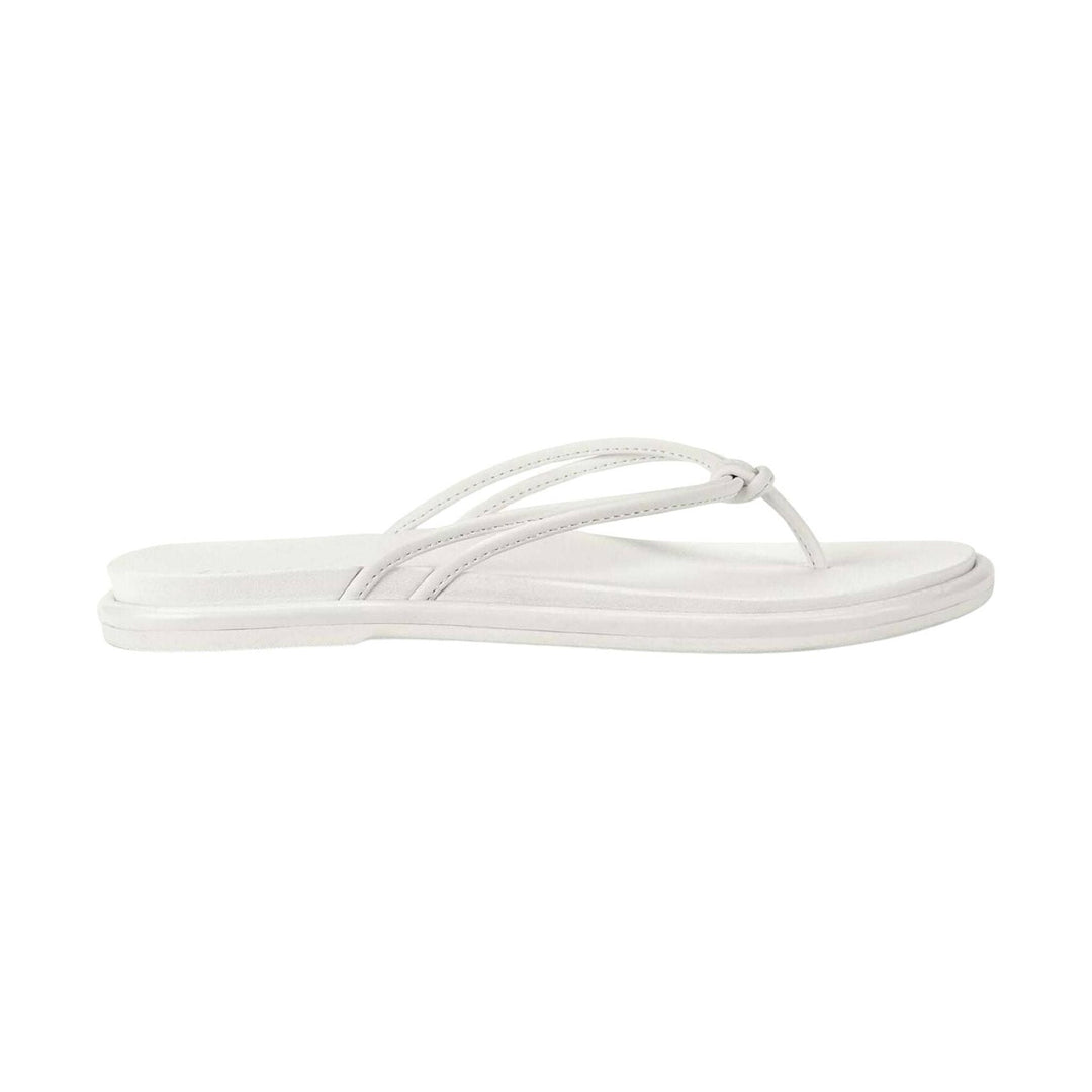 White thong sandal with thin crossover straps and a flat sole