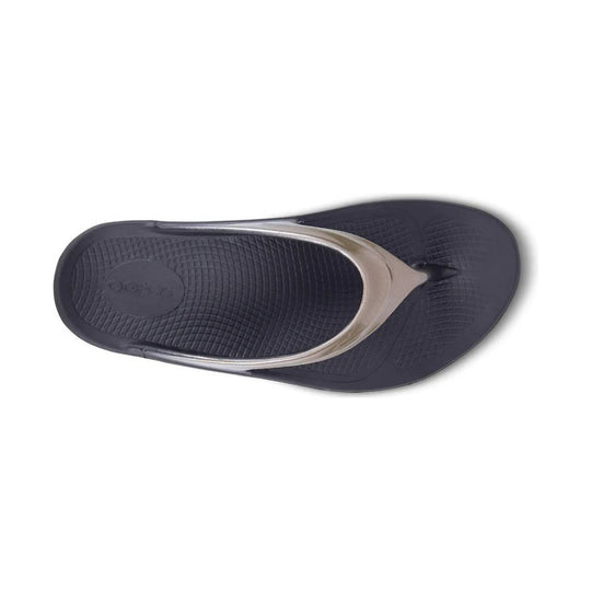 Dark navy thong sandal with a metallic strap and textured footbed, viewed from above