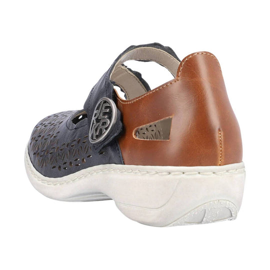 Closed-toe sandal in navy and tan leather with cutout detailing, white sole, and circular side logo
