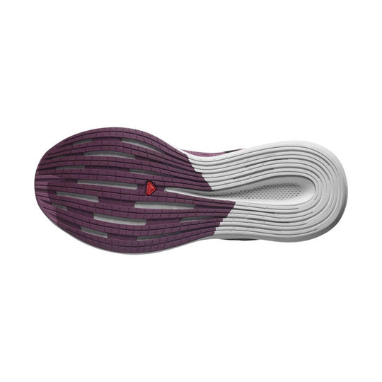 Purple and white running shoe outsole with a red logo insert