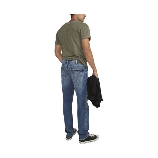 Back view of blue jeans on a model wearing a green T-shirt and black sneakers