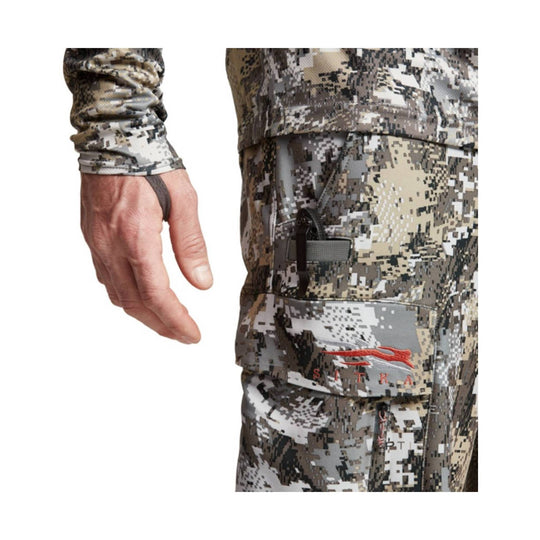 Camouflage cargo pant with side pocket and visible hand wearing a matching camo sleeve