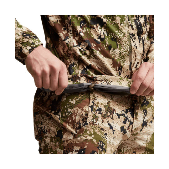 Camouflage zip-front jacket with a drawcord hem being held open