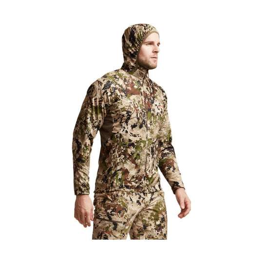 Camouflage hooded zip-up jacket with matching pants, shown on a model in profile