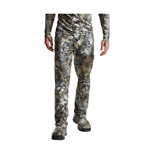 Camouflage long-sleeve top and pants worn with boots, shown from the waist down