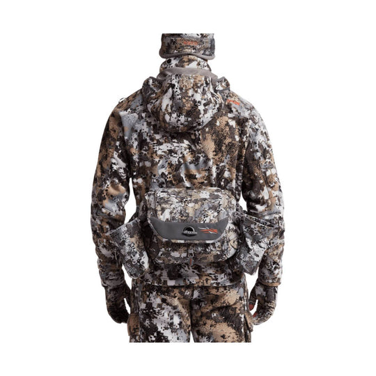 Camouflage utility pack with front flap pocket and side pouches, shown from the back.