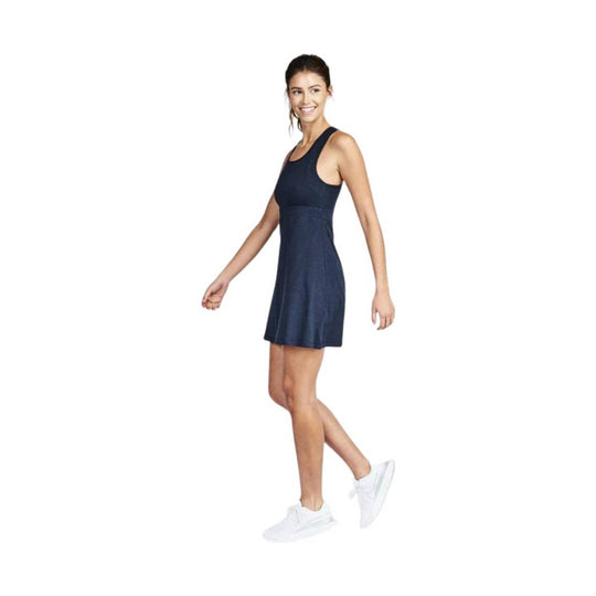 Sleeveless navy athletic dress with racerback cut and white sneakers