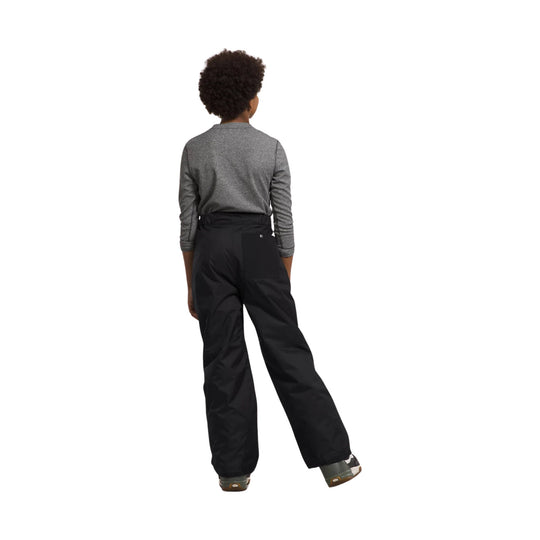 Black insulated ski pants shown from the back on a child model