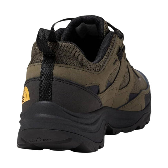 Low-cut hiking shoe in olive brown and black with a lugged sole, heel pull tab, and mesh collar